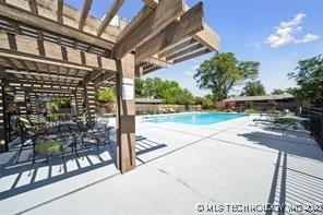 view of swimming pool with a pergola and a patio