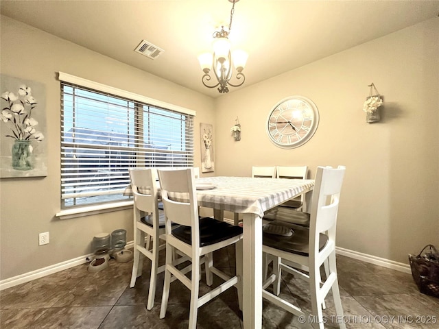 tiled dining area with an inviting chandelier