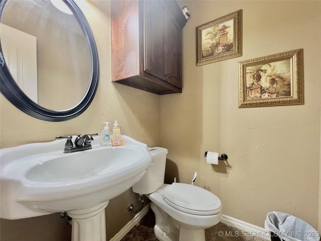 bathroom with toilet and sink