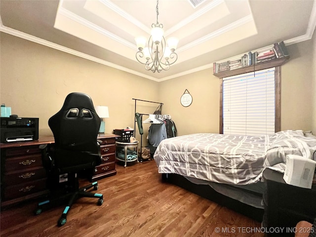 bedroom featuring a raised ceiling, crown molding, hardwood / wood-style flooring, and an inviting chandelier