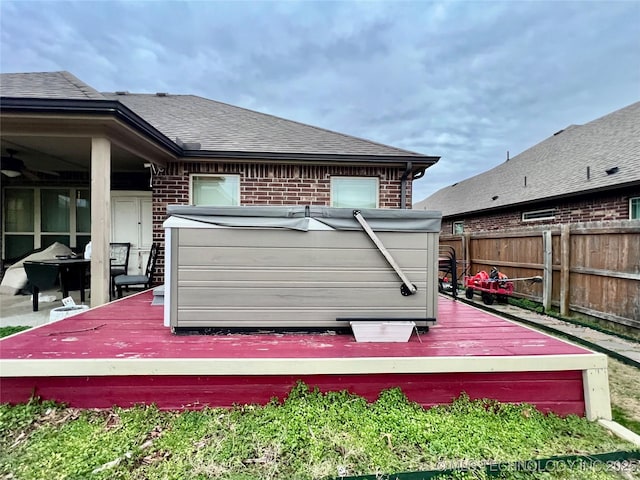 rear view of house featuring a wooden deck