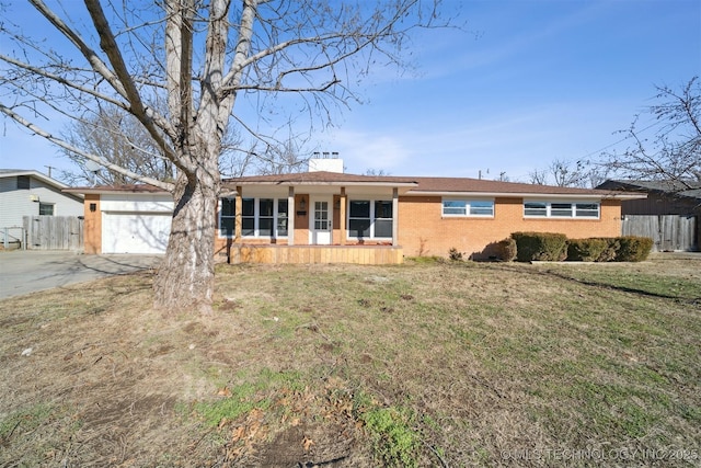 single story home featuring a porch, a garage, and a front yard