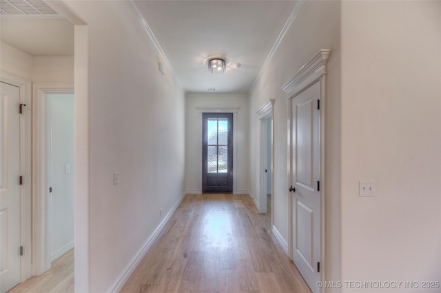 doorway to outside featuring crown molding and light wood-type flooring