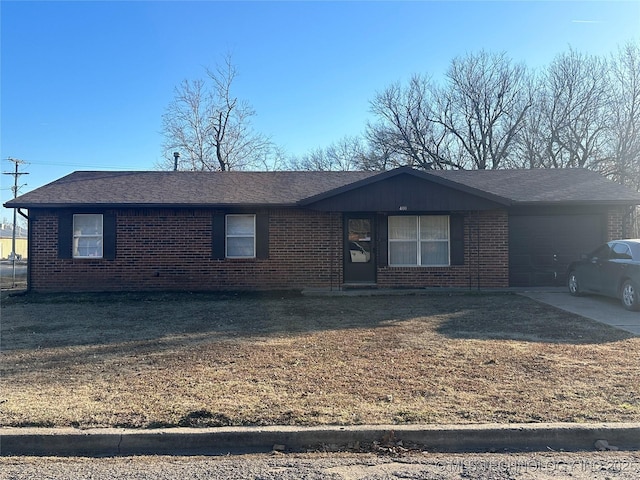 single story home with a garage and a front yard