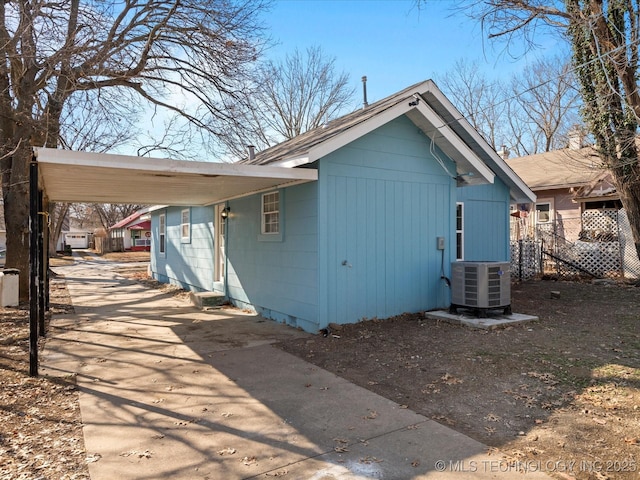 view of home's exterior featuring a carport and cooling unit