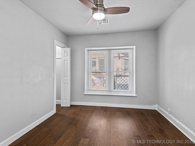 spare room with dark hardwood / wood-style floors and ceiling fan