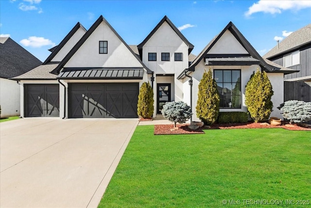 view of front of home with a garage and a front lawn