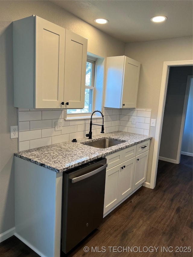 kitchen with dark wood-type flooring, sink, tasteful backsplash, dishwasher, and white cabinets