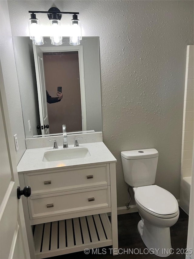 bathroom featuring vanity and toilet