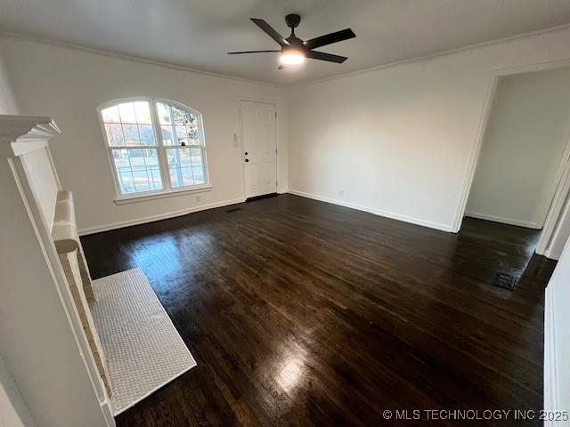 unfurnished living room featuring dark hardwood / wood-style flooring, ornamental molding, and ceiling fan