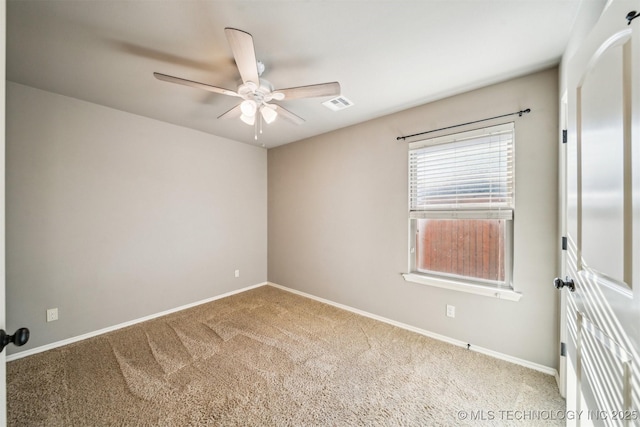 carpeted spare room with ceiling fan