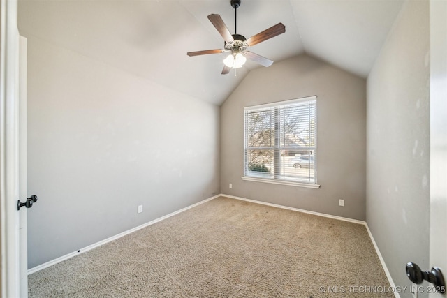 carpeted empty room with ceiling fan and vaulted ceiling