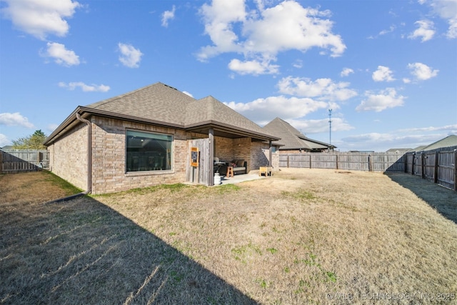 back of house with a yard and a patio area