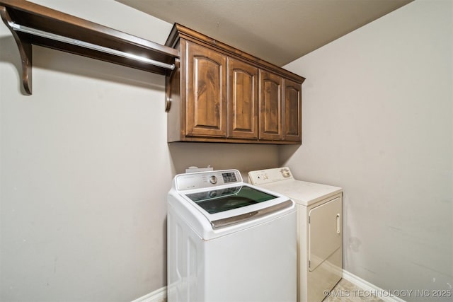 laundry area featuring cabinets and independent washer and dryer