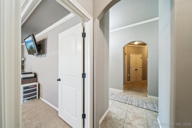 corridor featuring crown molding and light tile patterned flooring