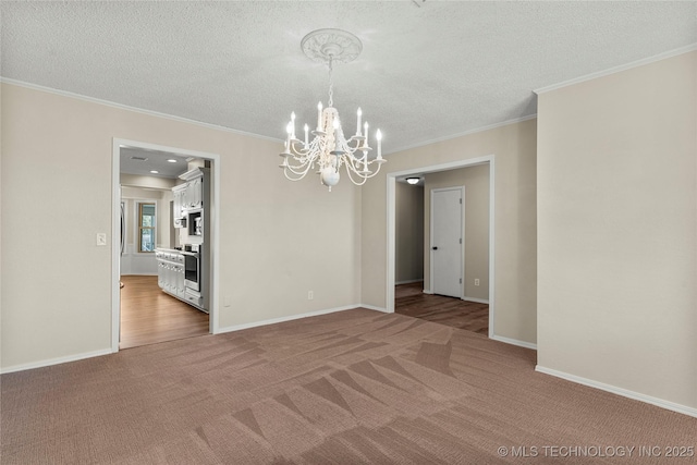 unfurnished room featuring crown molding, carpet floors, a notable chandelier, and a textured ceiling