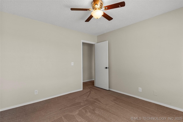 empty room featuring ceiling fan, carpet flooring, and a textured ceiling