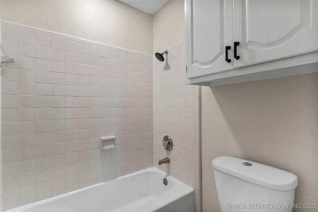 bathroom featuring tiled shower / bath combo and toilet