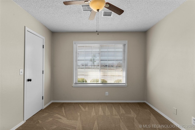 carpeted spare room with ceiling fan and a textured ceiling