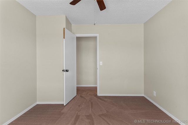 empty room featuring ceiling fan, carpet floors, and a textured ceiling