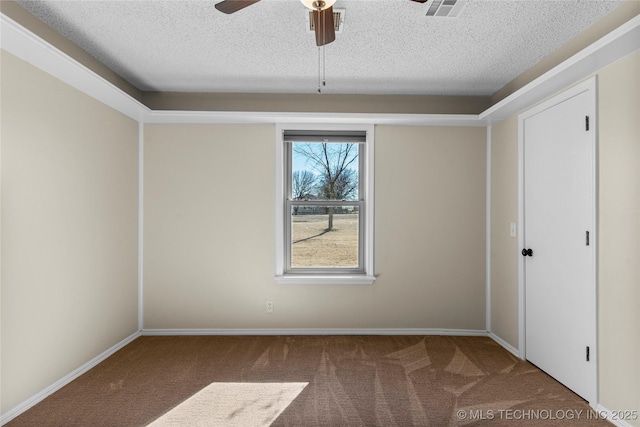 carpeted spare room featuring ceiling fan and a textured ceiling