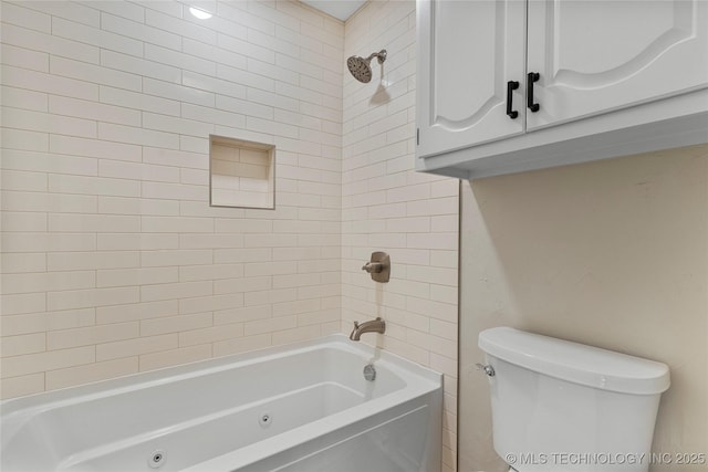 bathroom with tiled shower / bath and toilet