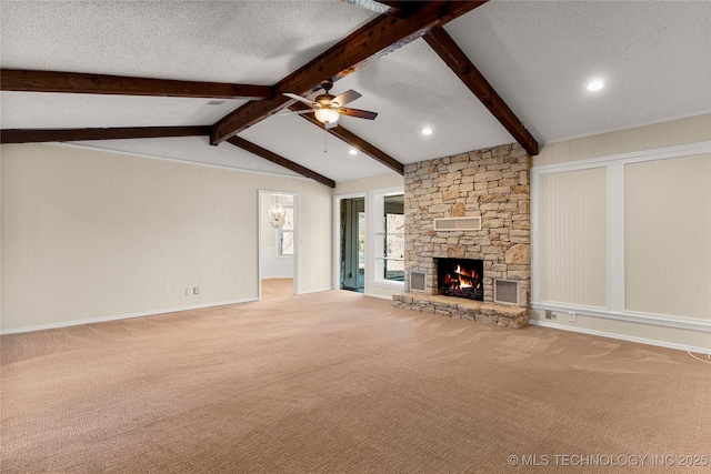 unfurnished living room with lofted ceiling with beams, light carpet, a textured ceiling, ceiling fan, and a fireplace