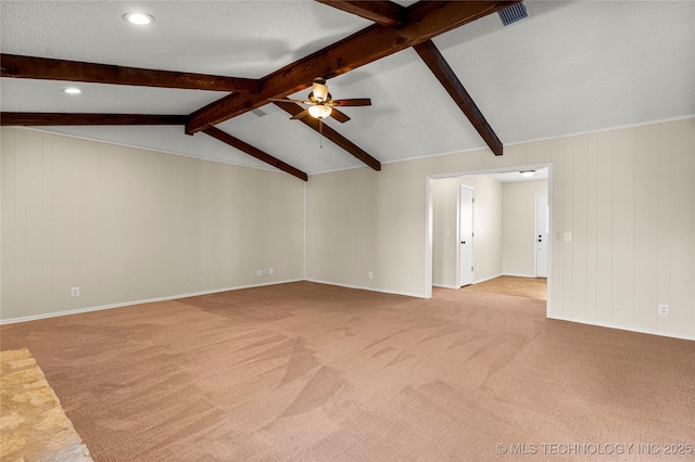 unfurnished living room with vaulted ceiling with beams, light colored carpet, a textured ceiling, and ceiling fan