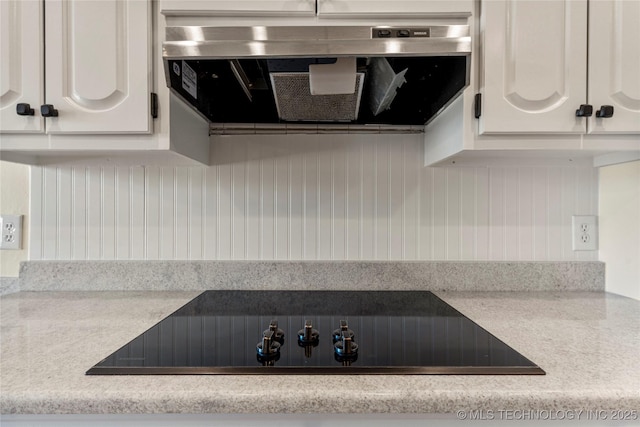 kitchen featuring white cabinetry, exhaust hood, and black electric cooktop