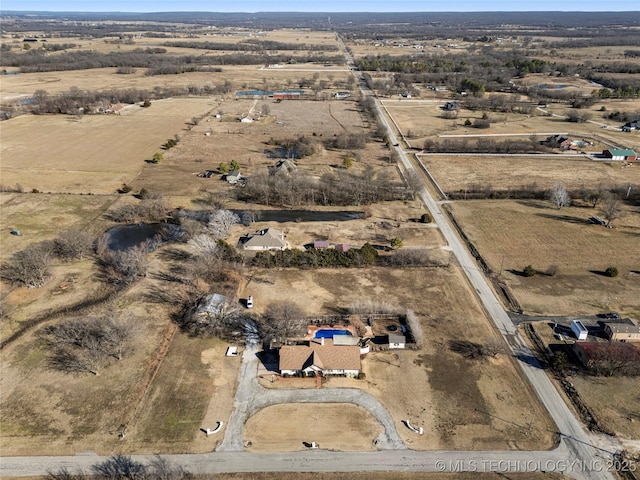 birds eye view of property with a rural view