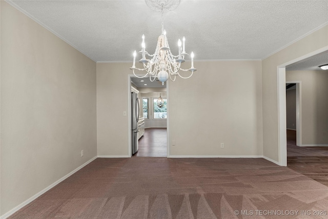 unfurnished dining area featuring dark colored carpet, crown molding, a textured ceiling, and a chandelier