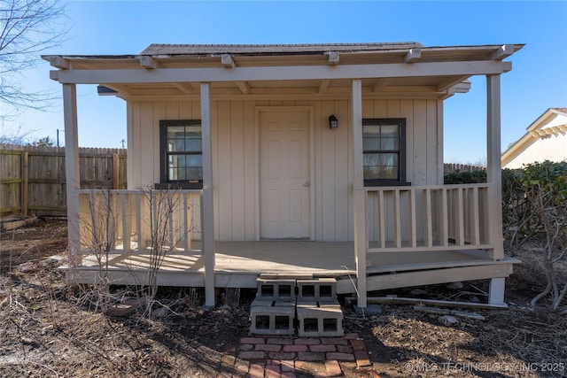 view of exterior entry with a deck