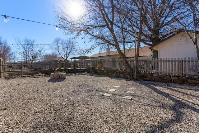 view of yard with an outdoor fire pit