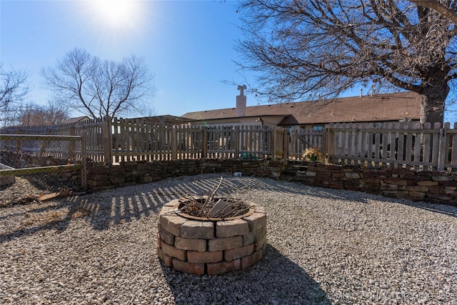 rear view of property with an outdoor fire pit