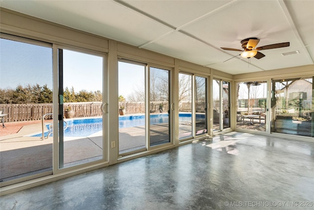 interior space with plenty of natural light, concrete floors, and ceiling fan