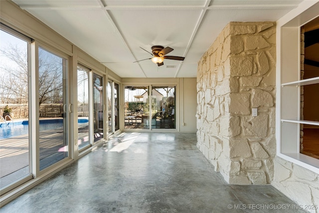 unfurnished sunroom with ceiling fan