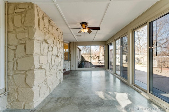 unfurnished sunroom with ceiling fan