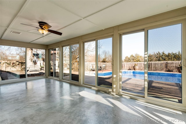 unfurnished sunroom featuring ceiling fan