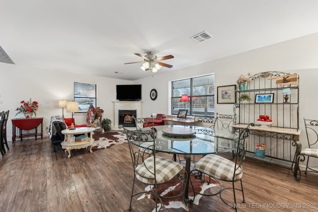 dining area with radiator, hardwood / wood-style floors, and ceiling fan