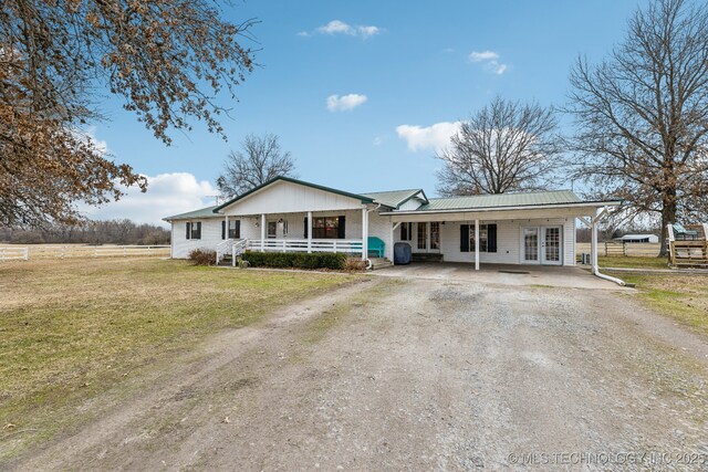 view of front of house with a carport, a front yard, and covered porch