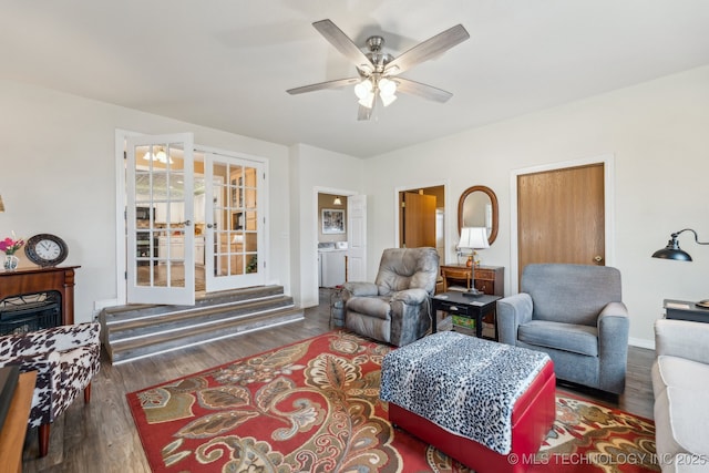 living room featuring dark hardwood / wood-style flooring, french doors, and ceiling fan