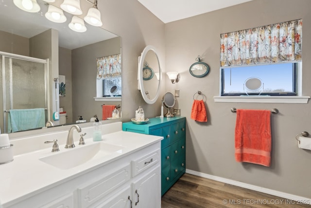 bathroom featuring hardwood / wood-style flooring, vanity, and walk in shower