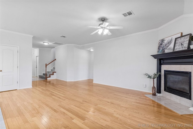 unfurnished living room with a fireplace, crown molding, light hardwood / wood-style flooring, and ceiling fan