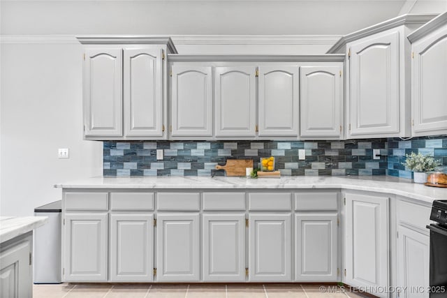 kitchen featuring crown molding, white cabinets, and decorative backsplash