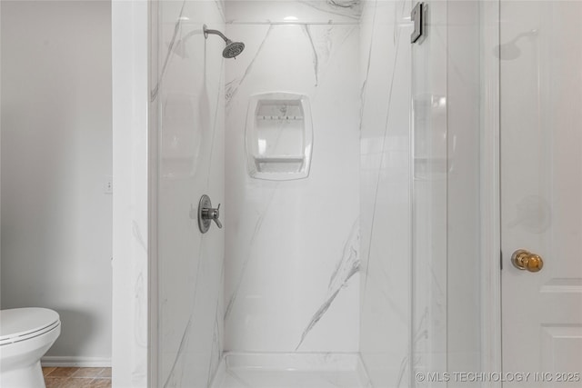 bathroom with a shower and toilet