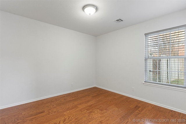 spare room featuring hardwood / wood-style flooring