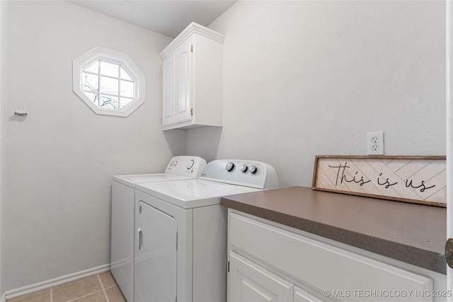 washroom with cabinets, washer and dryer, and light tile patterned floors