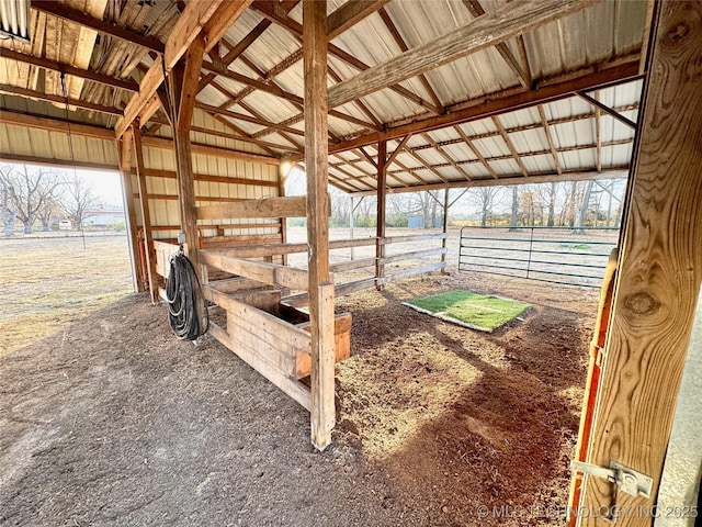 view of horse barn with a rural view