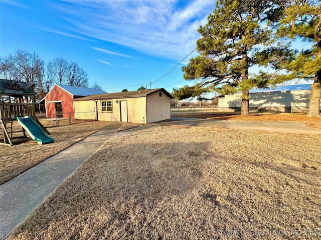 view of front of property with a playground