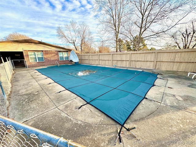 view of swimming pool featuring a patio area